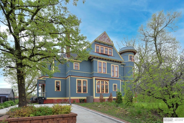 victorian home featuring cooling unit