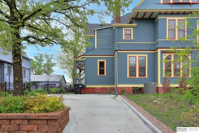 back of house featuring central AC