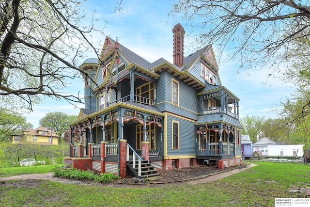 back of house with a lawn and a porch