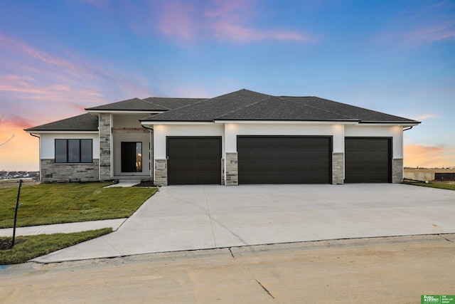 prairie-style home with a lawn and a garage