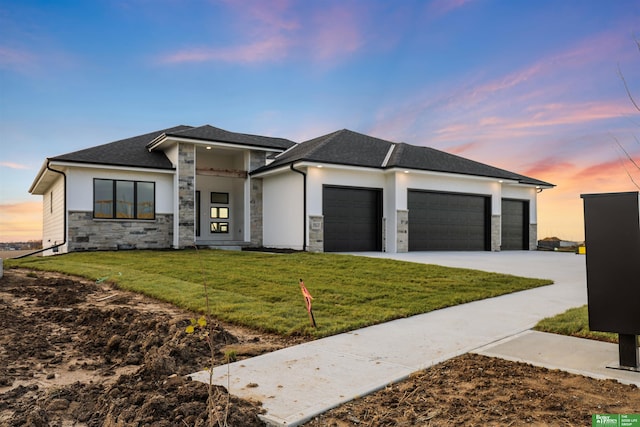 prairie-style house with a garage and a yard