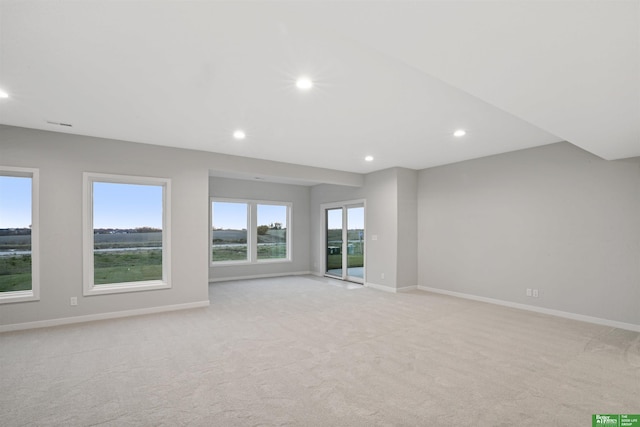 unfurnished room featuring light colored carpet