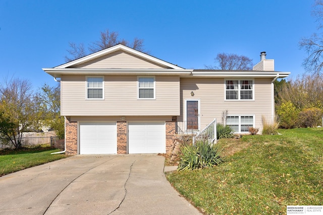 bi-level home featuring a garage and a front yard