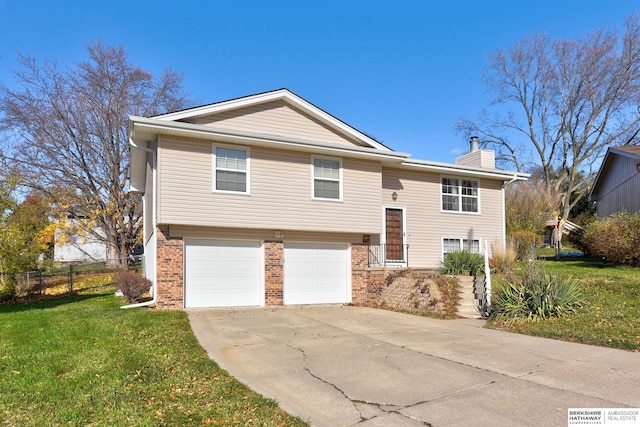 split foyer home featuring a front lawn and a garage