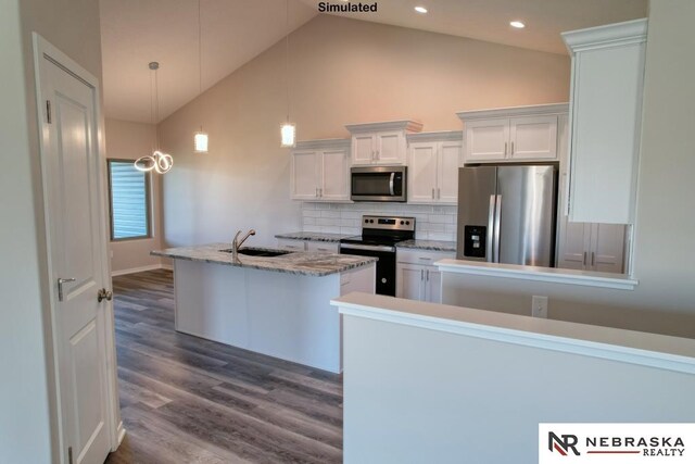 kitchen featuring stainless steel appliances, wood-type flooring, decorative light fixtures, high vaulted ceiling, and white cabinetry