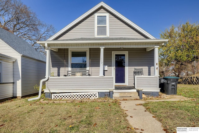 bungalow-style house with a front lawn