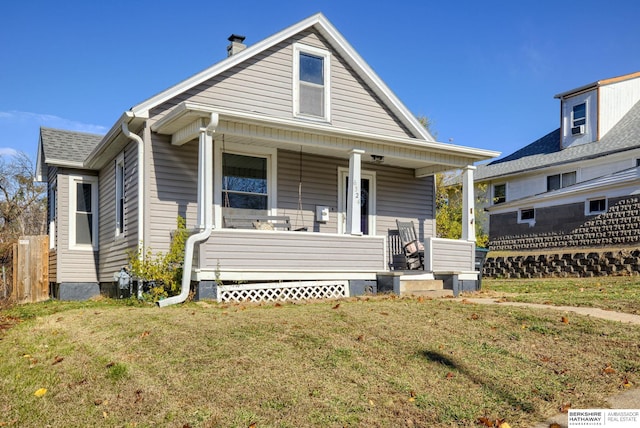 bungalow-style home with a porch and a front yard