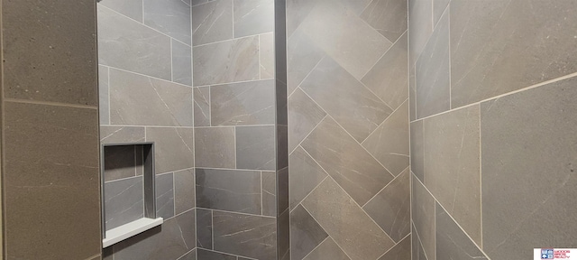 bathroom with a tile shower