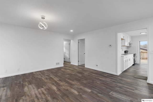 empty room featuring dark hardwood / wood-style flooring and sink