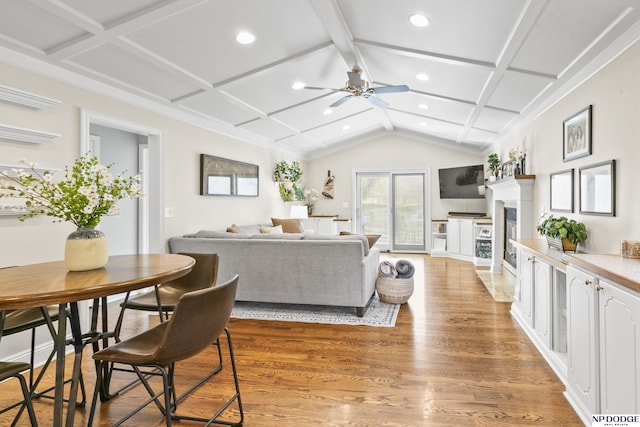 living room with ceiling fan, wood-type flooring, and coffered ceiling