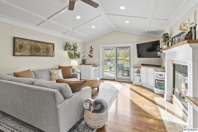 living room featuring ceiling fan, coffered ceiling, and light wood-type flooring