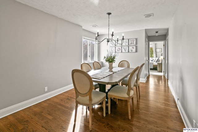 dining room featuring dark hardwood / wood-style floors, a wealth of natural light, and a notable chandelier