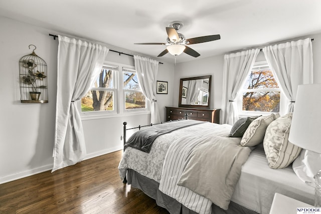 bedroom with dark hardwood / wood-style floors and ceiling fan