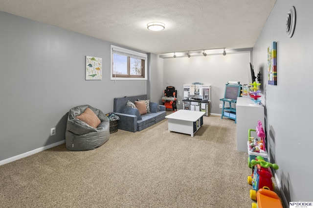 playroom with light colored carpet and a textured ceiling