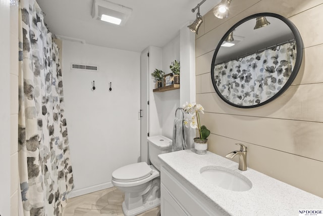 bathroom with vanity, toilet, and walk in shower