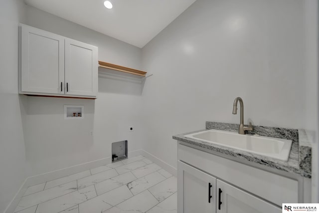 clothes washing area featuring cabinets, sink, washer hookup, and hookup for an electric dryer