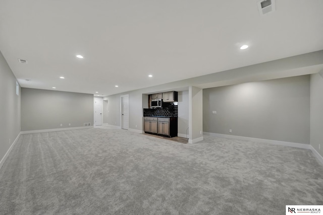 unfurnished living room with light carpet