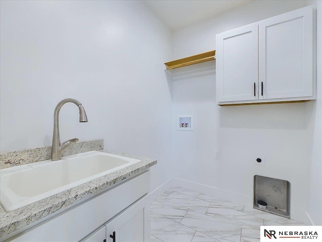 clothes washing area featuring electric dryer hookup, cabinets, sink, and hookup for a washing machine