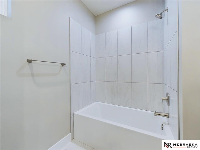 bathroom with tile patterned floors and tiled shower / bath