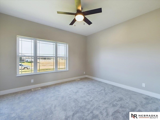 spare room with ceiling fan and carpet floors