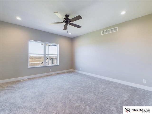 carpeted empty room featuring ceiling fan