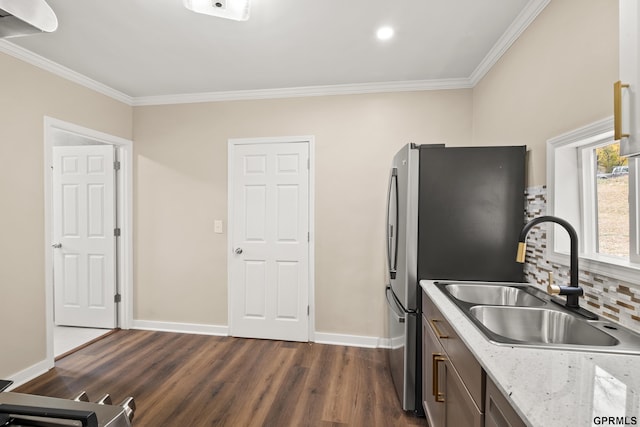 kitchen with backsplash, dark hardwood / wood-style flooring, ornamental molding, and sink