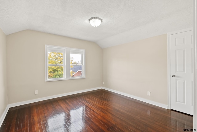 bonus room with a textured ceiling, dark hardwood / wood-style flooring, and vaulted ceiling