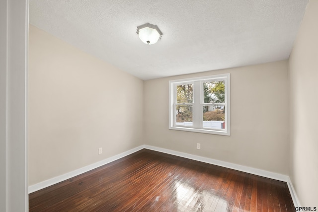 unfurnished room featuring hardwood / wood-style floors and a textured ceiling