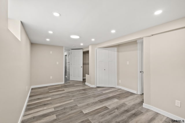 basement with light hardwood / wood-style flooring