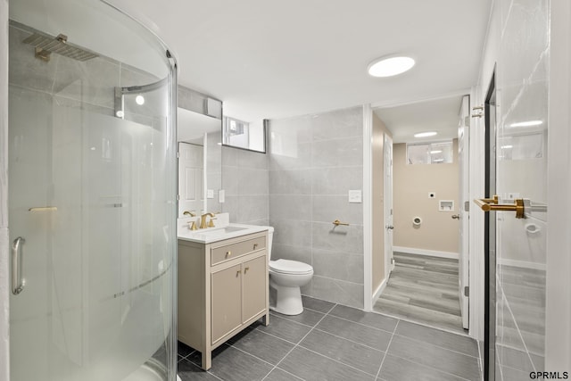 bathroom featuring walk in shower, vanity, hardwood / wood-style flooring, tile walls, and toilet