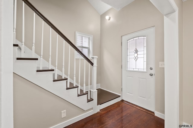 entryway with dark hardwood / wood-style floors and vaulted ceiling