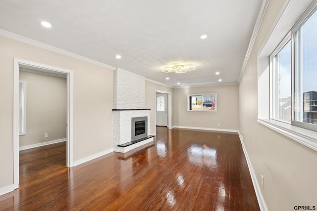 unfurnished living room featuring dark hardwood / wood-style floors, crown molding, and a fireplace