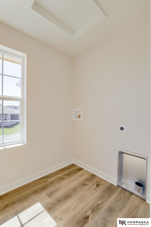 clothes washing area featuring hardwood / wood-style flooring, hookup for a washing machine, and electric dryer hookup