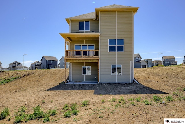 back of house featuring a balcony