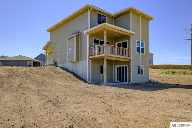 back of property with a balcony