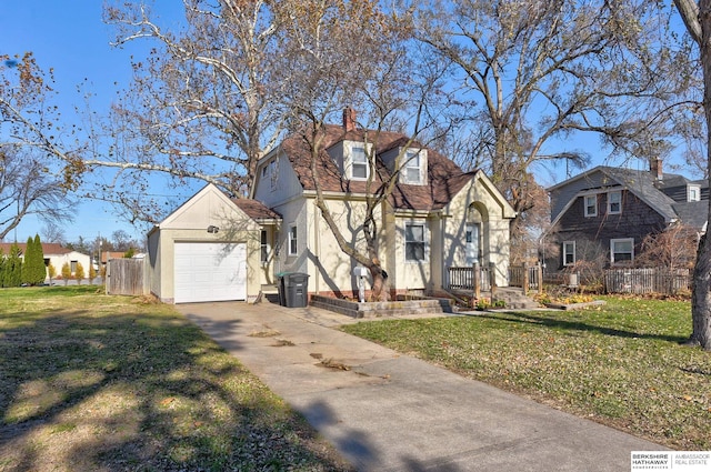 view of front of home with a front lawn and a garage