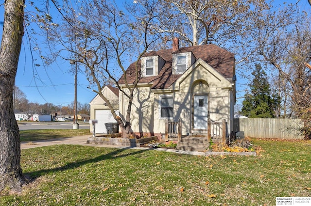 view of front of property featuring a garage and a front lawn