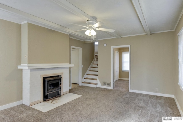 unfurnished living room with ceiling fan, ornamental molding, and light carpet