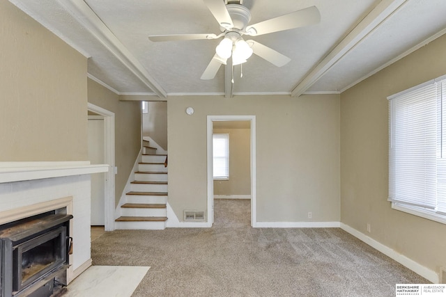 unfurnished living room featuring a textured ceiling, light colored carpet, ceiling fan, and crown molding