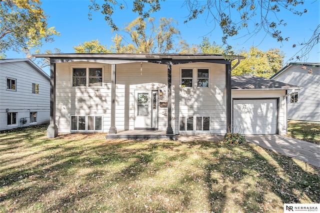 bi-level home featuring a front yard and a garage