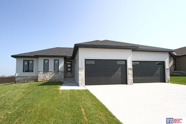 prairie-style house with a garage and a front yard