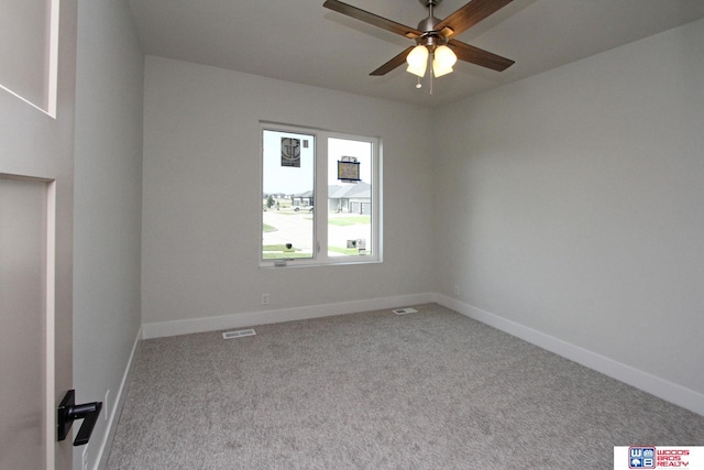 carpeted spare room featuring ceiling fan