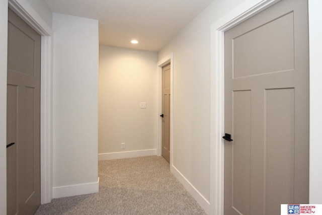 hallway featuring light carpet