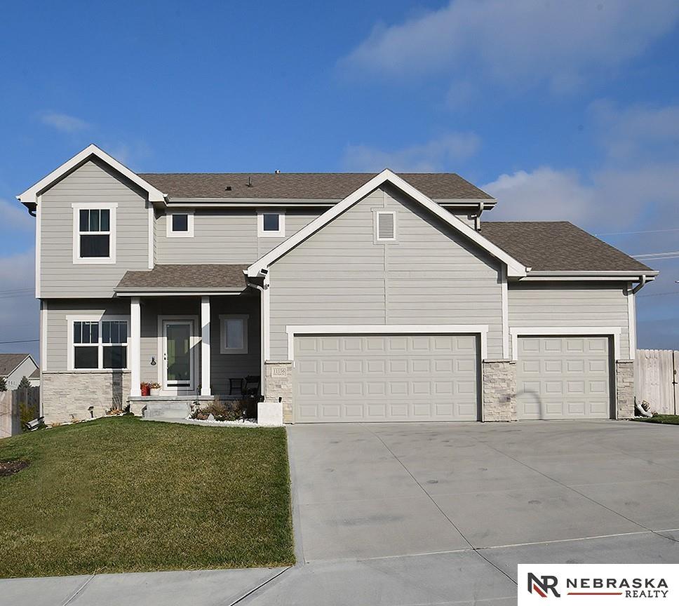 view of front of property featuring a garage and a front lawn