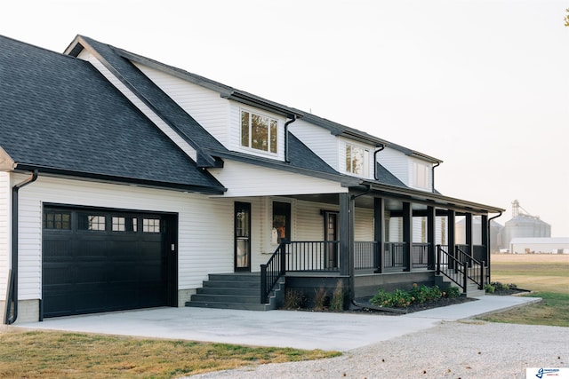 view of front facade featuring a porch and a garage