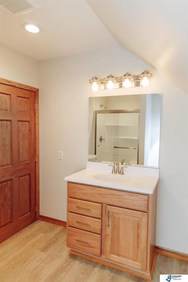 803 N 30th Rd, Syracuse, NE 68446 - bathroom featuring vanity, wood finished floors, and a shower