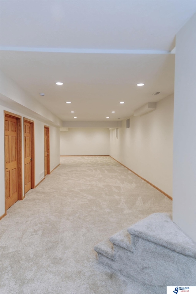 basement with light colored carpet