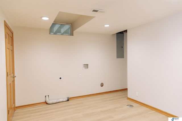 washroom with electric panel, hookup for an electric dryer, light hardwood / wood-style floors, and washer hookup