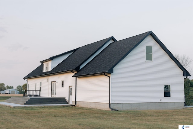 view of side of home with a lawn