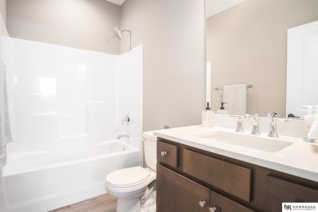 full bathroom featuring toilet, vanity, wood-type flooring, and tub / shower combination